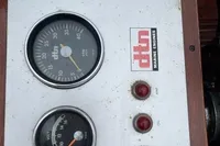 Instrument panel of a 1926 custom motorboat with gauges and dtn marine engines logo.