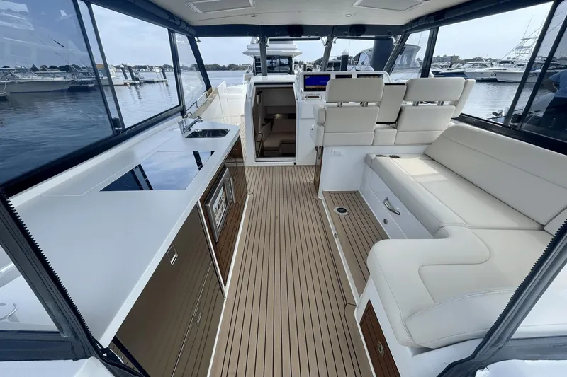  Yacht Photos Pics Luxurious interior of 2024 MJM 4 yacht with seating and kitchenette.