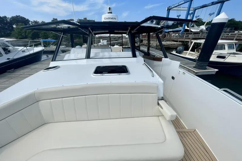  Yacht Photos Pics 2024 MJM 4 boat with Garmin equipment, docked at a marina.