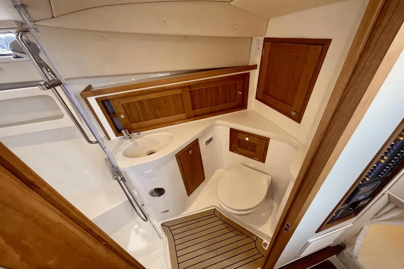  Yacht Photos Pics 2024 MJM 4 yacht bathroom with wooden cabinets and modern fixtures.
