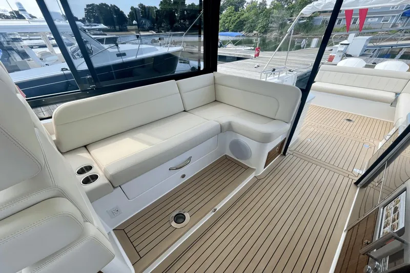  Yacht Photos Pics 2024 MJM 4 yacht interior with white seating and teak flooring.