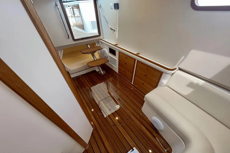  Yacht Photos Pics Luxurious interior of 2024 MJM 4 yacht with wood flooring and elegant seating.