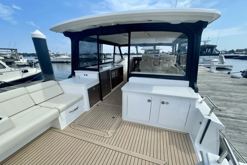  Yacht Photos Pics 2024 MJM 4 yacht with spacious deck and luxurious seating at marina.