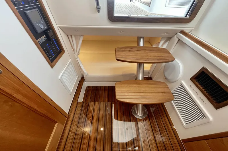  Yacht Photos Pics 2024 MJM 4 yacht interior with wooden steps and control panel.
