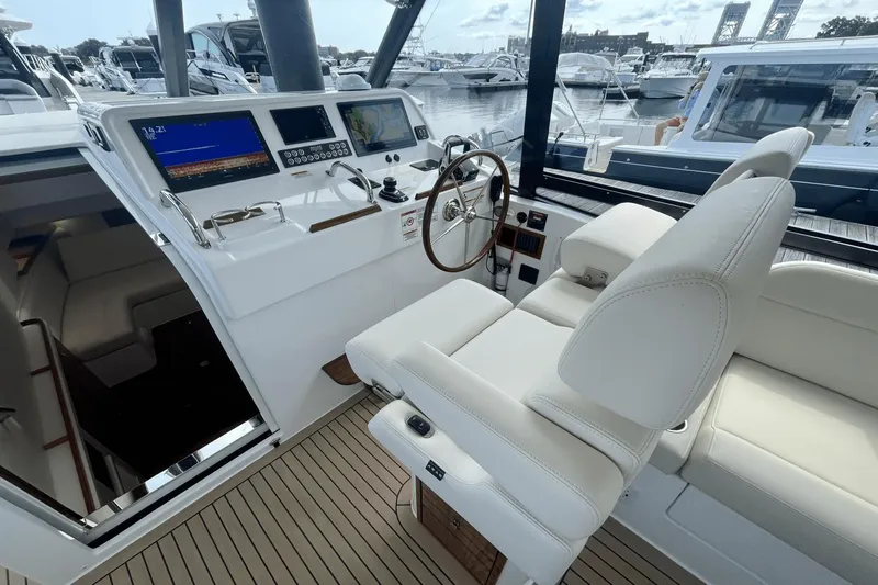  Yacht Photos Pics 2024 MJM 4 yacht helm with modern controls and luxurious seating at marina.