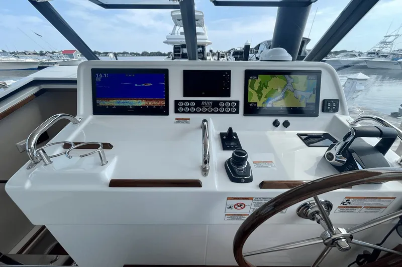  Yacht Photos Pics Helm of 2024 MJM 4 boat with navigation screens and controls at marina.