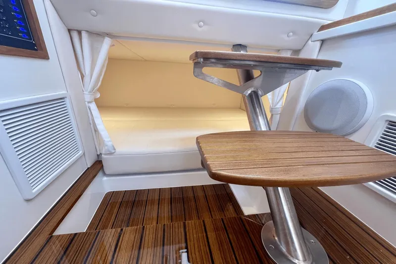  Yacht Photos Pics 2024 MJM 4 interior with wooden steps and cozy cabin space.