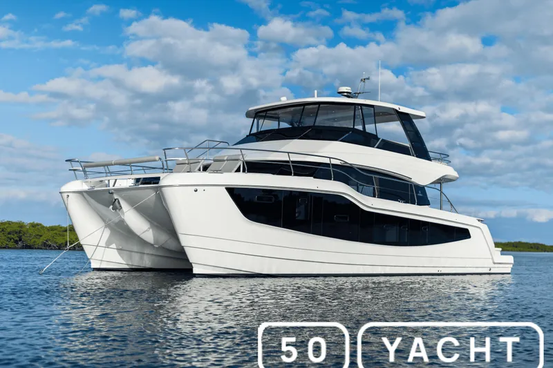  Yacht Photos Pics Aquila New 2026 yacht on water under blue sky, showcasing modern design.