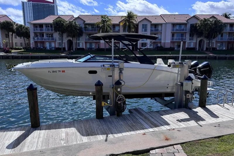  Yacht Photos Pics 2024 Sea Ray SDX 290 Outboard boat docked by waterfront homes.