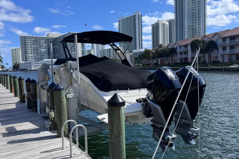  Yacht Photos Pics 2024 Sea Ray SDX 290 Outboard docked with cityscape background.