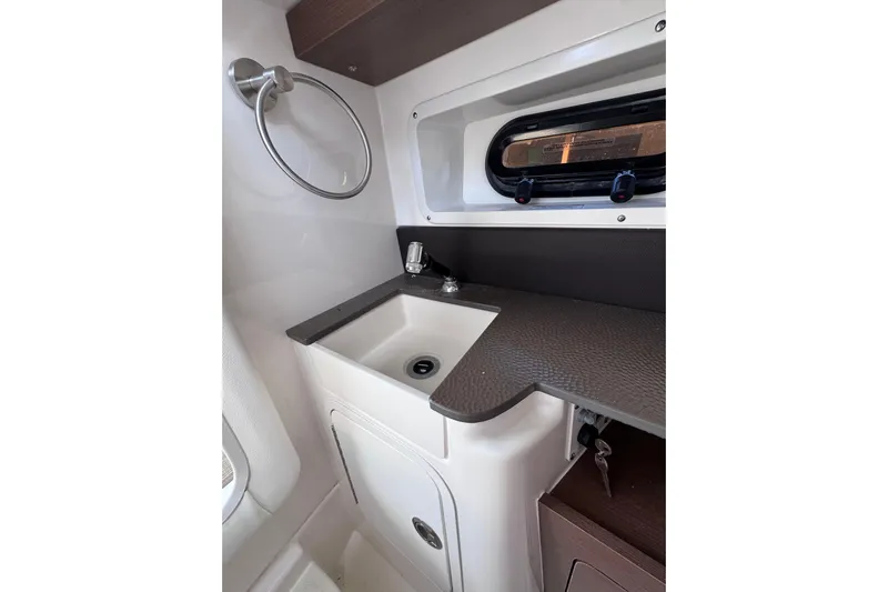  Yacht Photos Pics 2024 Sea Ray SDX 290 Outboard interior sink area with window and countertop.