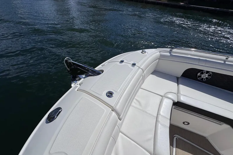  Yacht Photos Pics 2024 Sea Ray SDX 290 Outboard boat with white seating, docked on calm water.