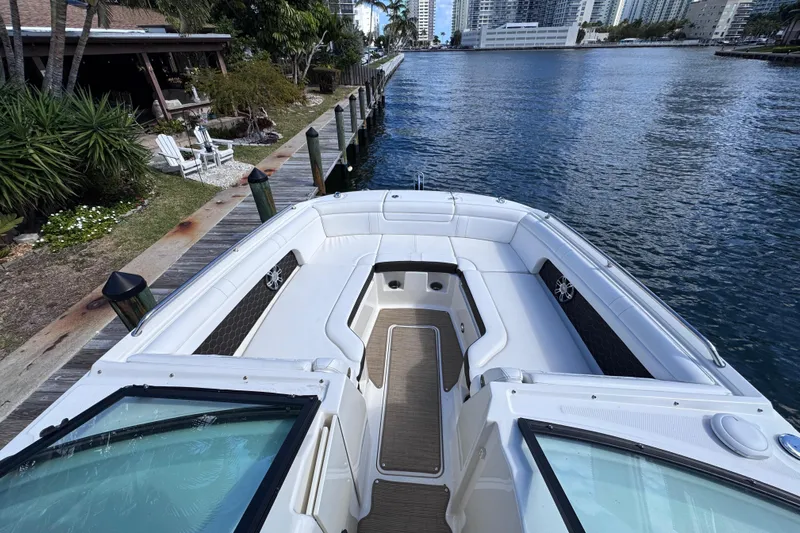  Yacht Photos Pics 2024 Sea Ray SDX 290 Outboard boat docked by waterfront, featuring spacious seating.
