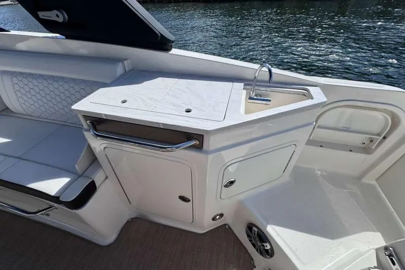  Yacht Photos Pics 2024 Sea Ray SDX 290 Outboard boat interior with sink and seating area.