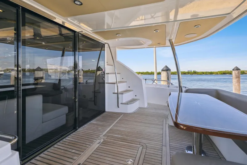  Yacht Photos Pics 2014 Sunseeker Manhattan 73 yacht deck with elegant seating and scenic water view.