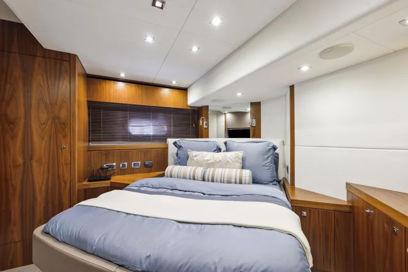  Yacht Photos Pics Luxurious bedroom interior of 2014 Sunseeker Manhattan 73 yacht with modern wood finishes.