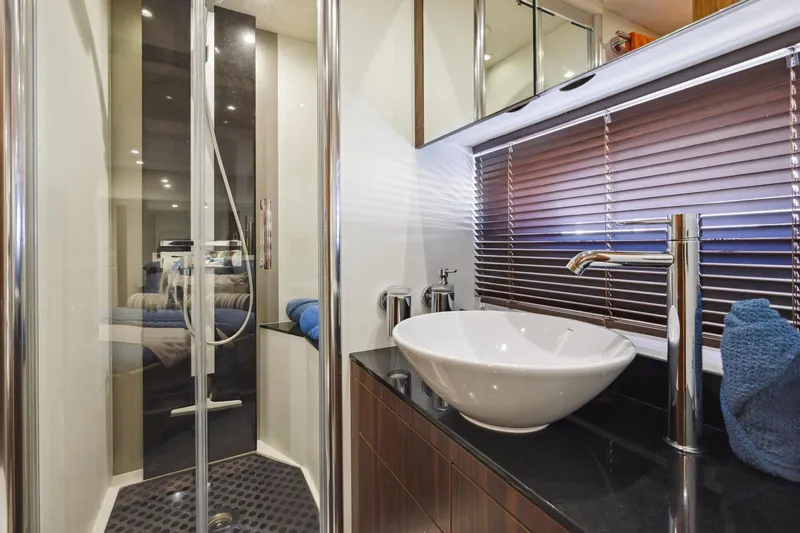  Yacht Photos Pics Luxurious bathroom in 2014 Sunseeker Manhattan 73 yacht with modern fixtures and elegant design.