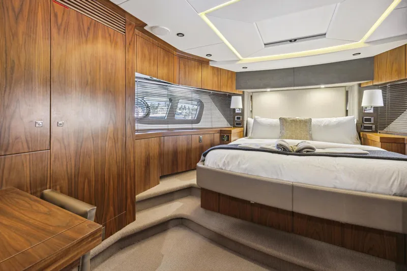  Yacht Photos Pics Luxurious Sunseeker Manhattan 73 yacht bedroom, 2014 model, featuring elegant wood paneling and modern design.