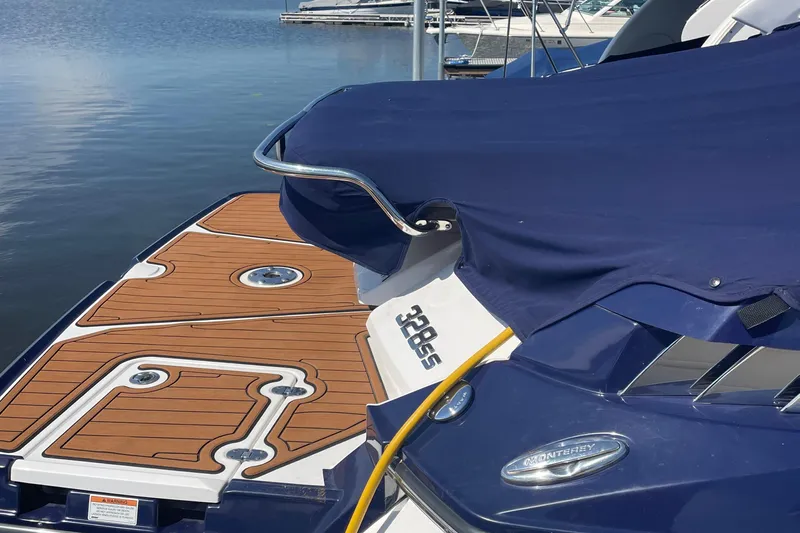  Yacht Photos Pics 2018 Monterey 328 Super Sport boat with blue cover and wooden deck at marina.