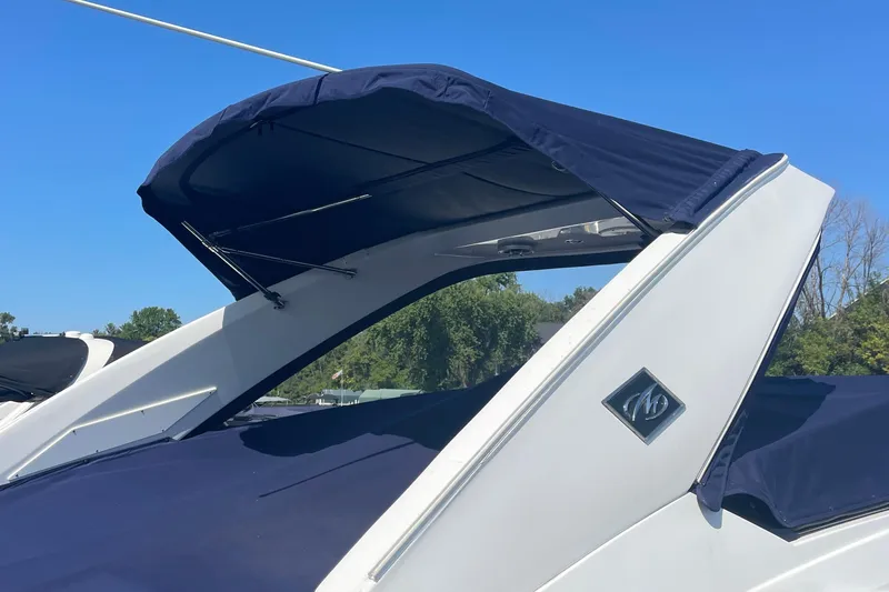  Yacht Photos Pics 2018 Monterey 328 Super Sport boat with blue canopy and sleek design.