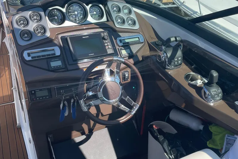  Yacht Photos Pics Cockpit of 2018 Monterey 328 Super Sport boat with modern controls and steering wheel.