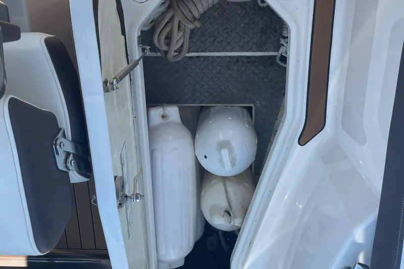  Yacht Photos Pics Storage compartment on a 2018 Monterey 328 Super Sport boat with fenders and rope.