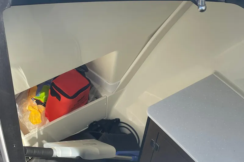  Yacht Photos Pics Interior storage area of a 2018 Monterey 328 Super Sport boat with various items.