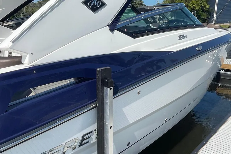  Yacht Photos Pics 2018 Monterey 328 Super Sport boat docked, featuring sleek white and blue design.