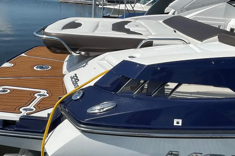  Yacht Photos Pics 2018 Monterey 328 Super Sport boat docked, featuring sleek design and wooden deck accents.