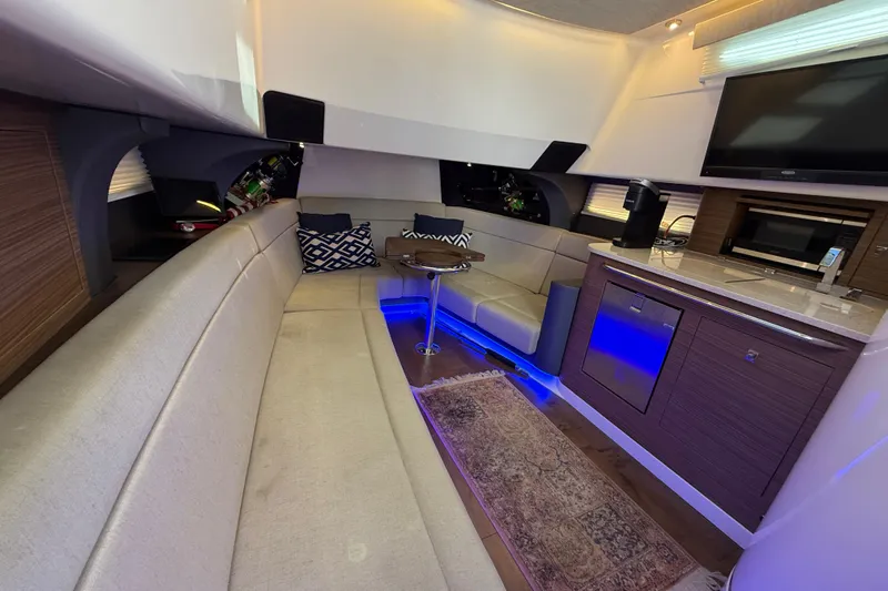  Yacht Photos Pics Luxurious interior of 2020 Boston Whaler 420 Outrage with seating, kitchenette, and ambient lighting.