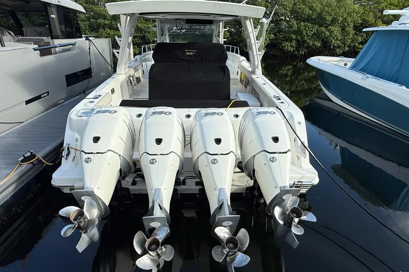  Yacht Photos Pics 2020 Boston Whaler 420 Outrage with four powerful outboard engines docked at marina.