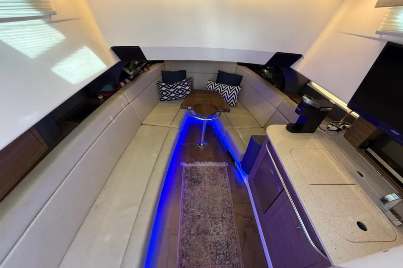  Yacht Photos Pics 2020 Boston Whaler 420 Outrage interior with modern seating, ambient lighting, and kitchenette.