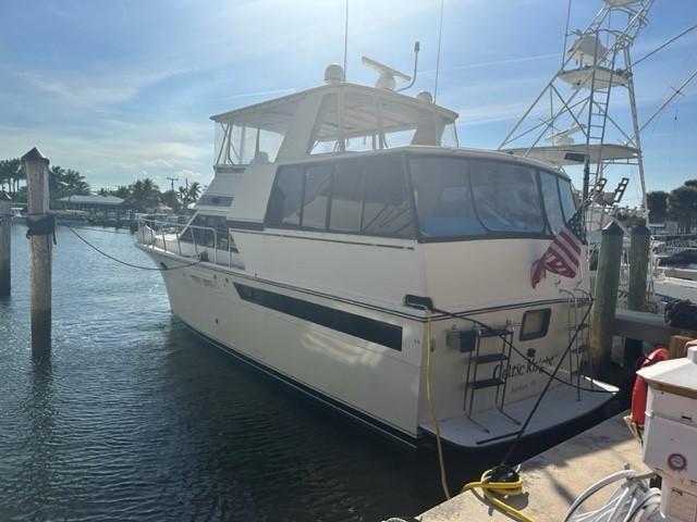 1989 Californian 48 Motor Yacht docked at marina, sunny day, American flag displayed.