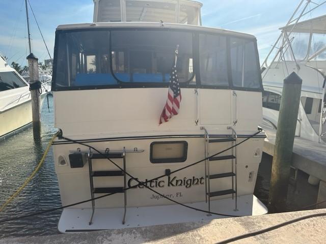 1989 Californian 48 Motor Yacht docked, rear view with American flag.