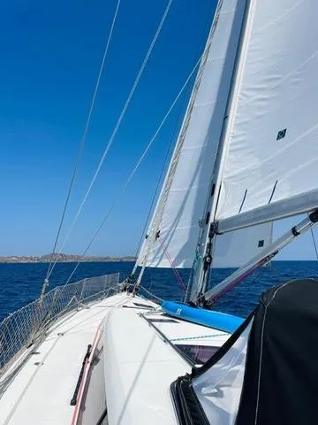  Yacht Photos Pics Beneteau Sense 50 sailboat cruising on open sea under clear blue sky.