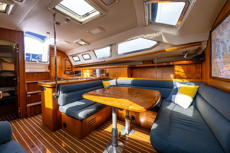Selkie Yacht Photos Pics 2007 Hunter 41 Deck Salon interior with skylights, wooden finishes, and blue seating.