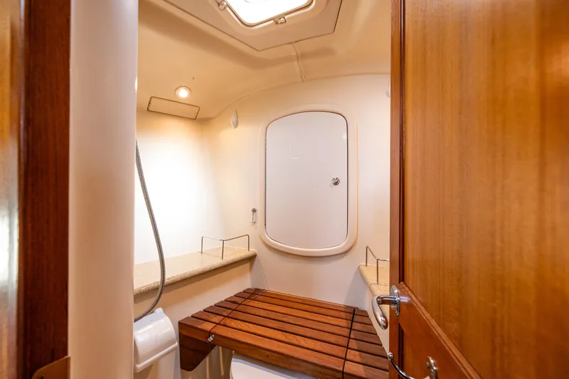 Selkie Yacht Photos Pics 2007 Hunter 41 Deck Salon bathroom with wooden bench and modern fixtures.