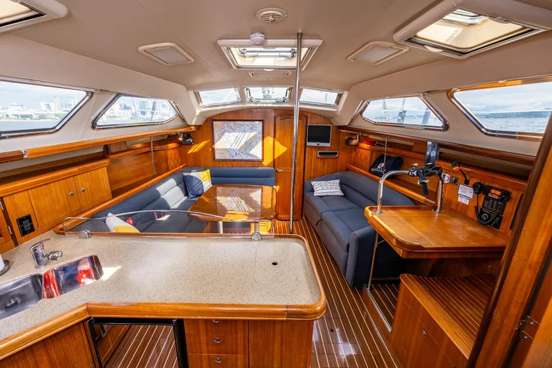 Selkie Yacht Photos Pics Luxurious interior of 2007 Hunter 41 Deck Salon yacht with wood finish and modern amenities.