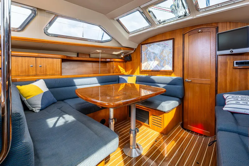 Selkie Yacht Photos Pics Luxurious interior of 2007 Hunter 41 Deck Salon with elegant wood finish and plush seating.
