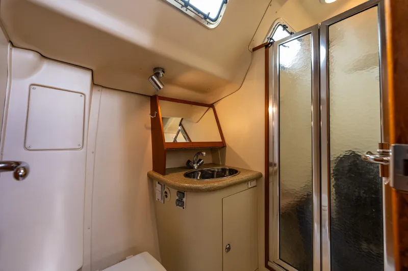 Selkie Yacht Photos Pics 2007 Hunter 41 Deck Salon bathroom with sink, mirror, and shower.