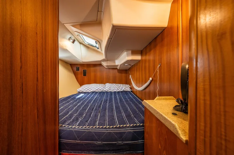 Selkie Yacht Photos Pics Cozy cabin interior of 2007 Hunter 41 Deck Salon with wood paneling and a comfortable bed.