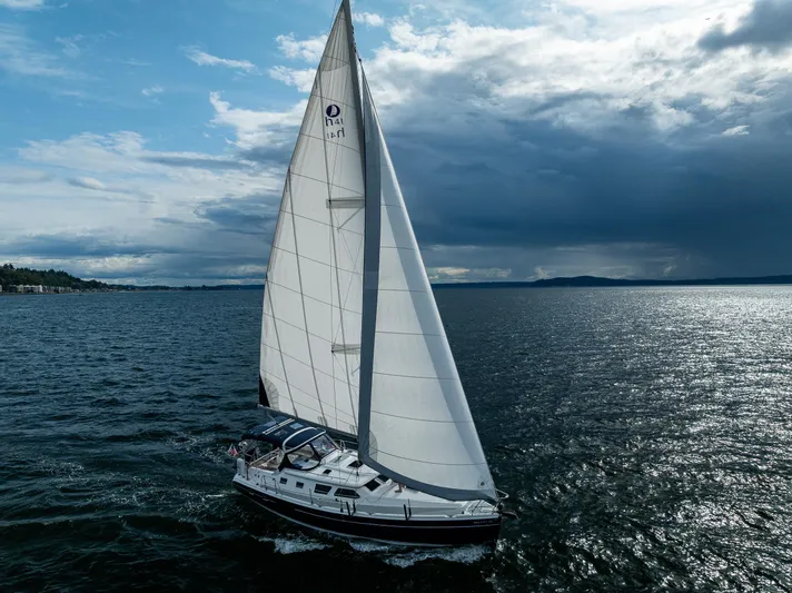 Selkie Yacht Photos Pics Sailing yacht Hunter 41 Deck Salon 2007 on open water under cloudy sky.