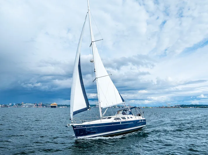 Selkie Yacht Photos Pics Sailing yacht Hunter 41 Deck Salon 2007 on open water under cloudy skies.