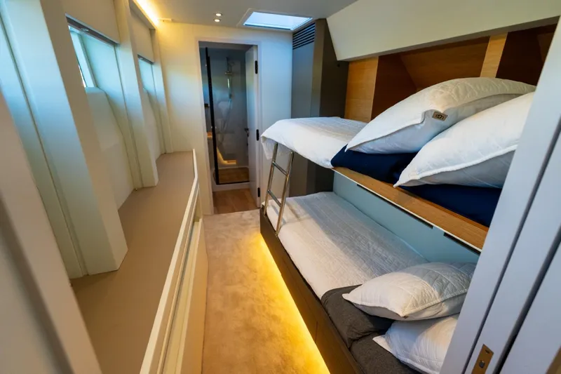 Bikini Bottom Yacht Photos Pics Luxurious 2023 Granocean 57 yacht interior with modern bunk beds and ambient lighting.