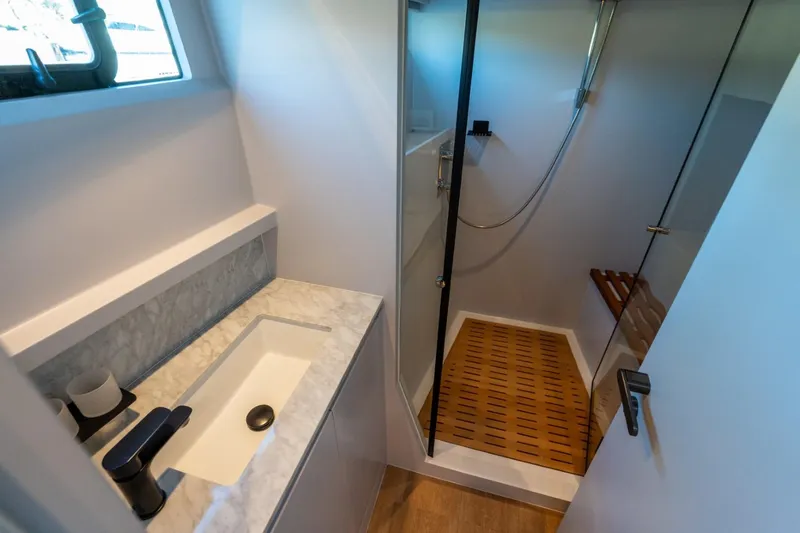 Bikini Bottom Yacht Photos Pics Luxurious bathroom in 2023 Granocean 57 yacht with modern shower and marble sink.