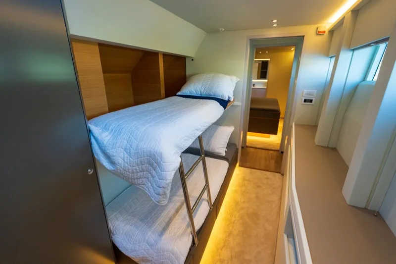 Bikini Bottom Yacht Photos Pics Luxurious interior of 2023 Granocean 57 yacht with modern bunk beds and ambient lighting.