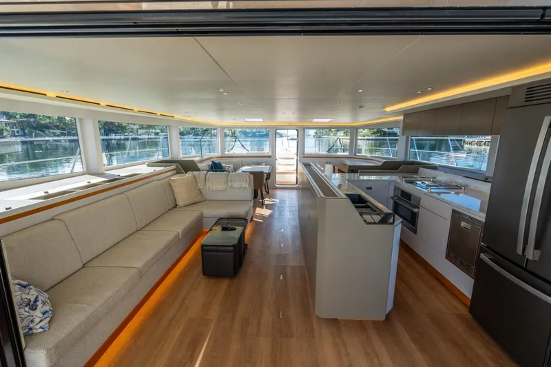 Bikini Bottom Yacht Photos Pics Luxurious interior of 2023 Granocean 57 yacht with modern kitchen and spacious seating area.