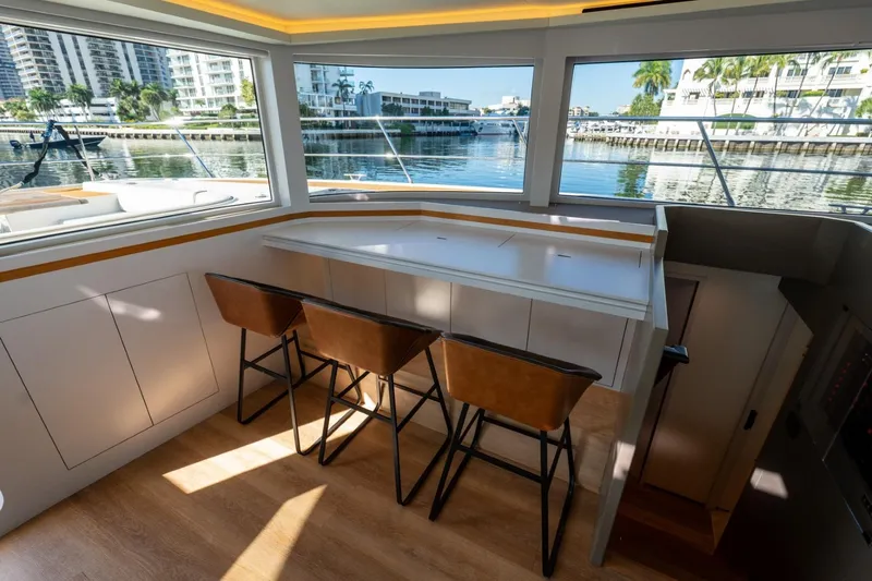 Bikini Bottom Yacht Photos Pics Luxurious interior of 2023 Granocean 57 yacht with waterfront view and stylish seating.