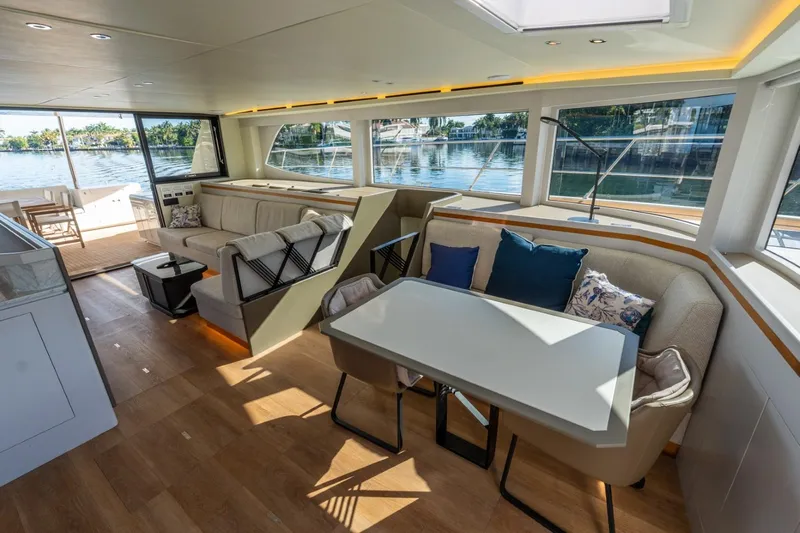 Bikini Bottom Yacht Photos Pics Luxurious interior of 2023 Granocean 57 yacht with modern seating and scenic windows.