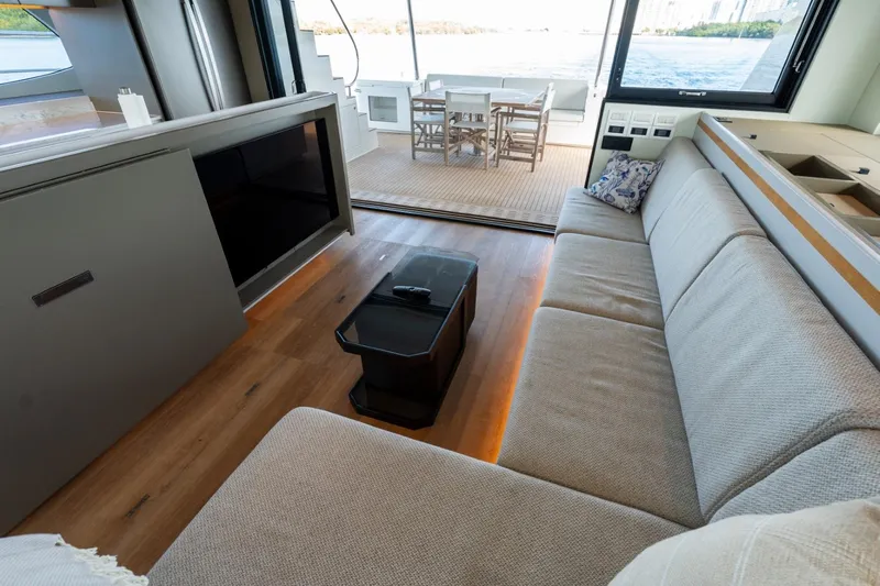 Bikini Bottom Yacht Photos Pics Luxurious interior of 2023 Granocean 57 yacht with spacious seating and outdoor dining area.